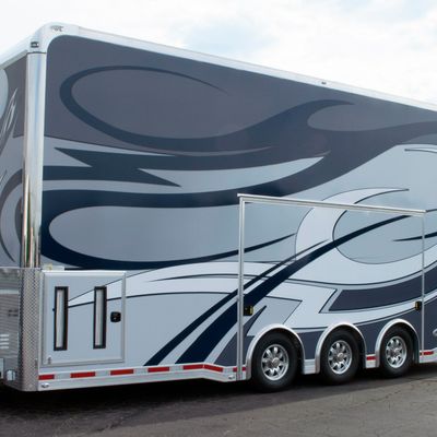 A trailer with a custom decorative tribal vinyl wrap with white, navy and black lines and swirls.