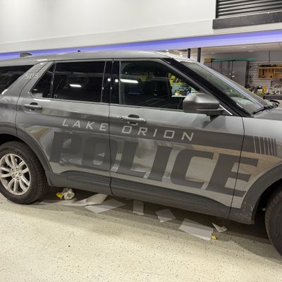 A police vehicle wrapped with a stealth matte design and livery