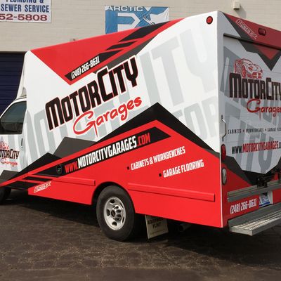 A commercial work box truck with a custom vinyl wrap with red, white, and black logos and text with a simple design