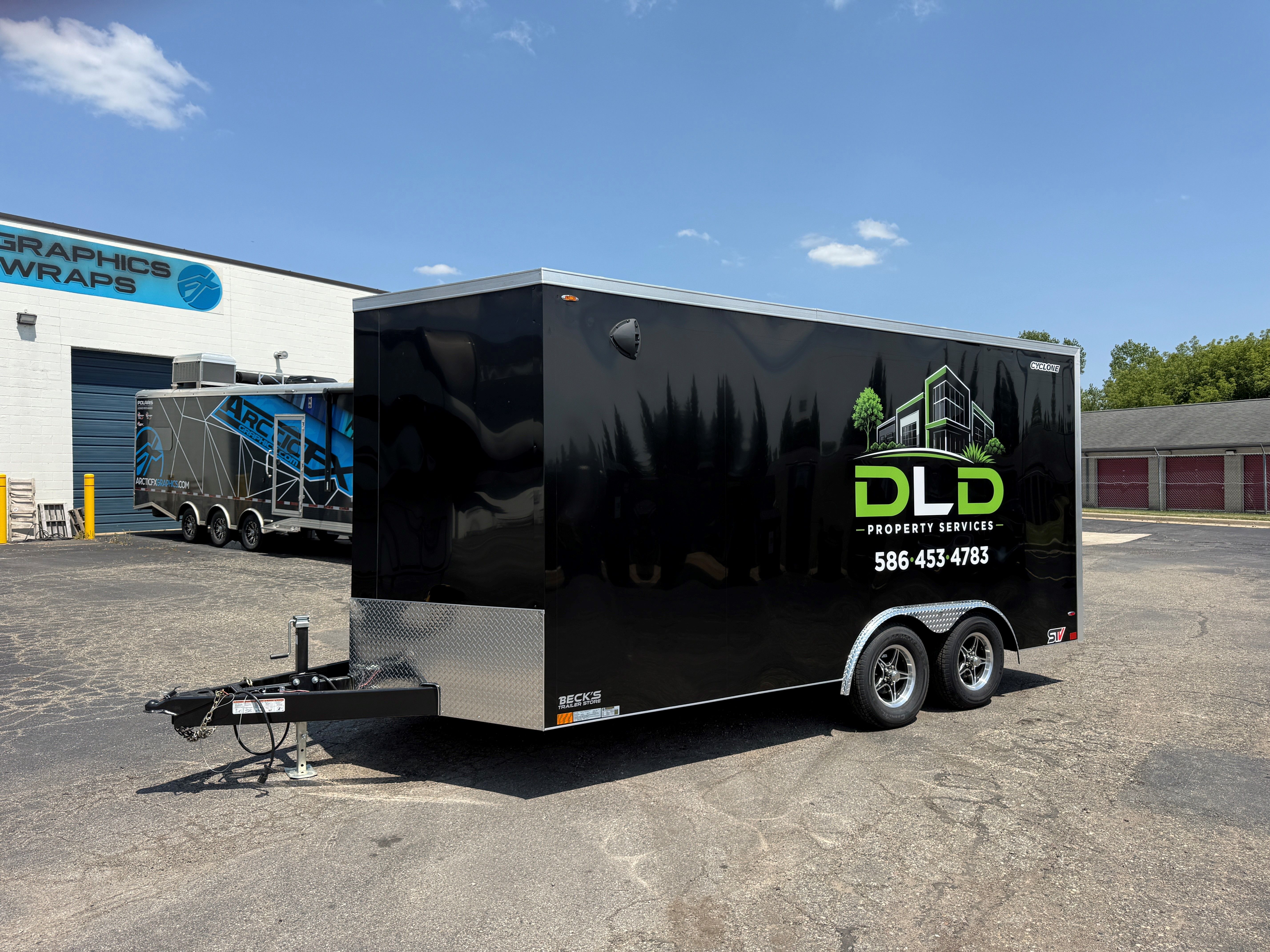A commercial trailer with a custom vinyl wrap with green logos and design