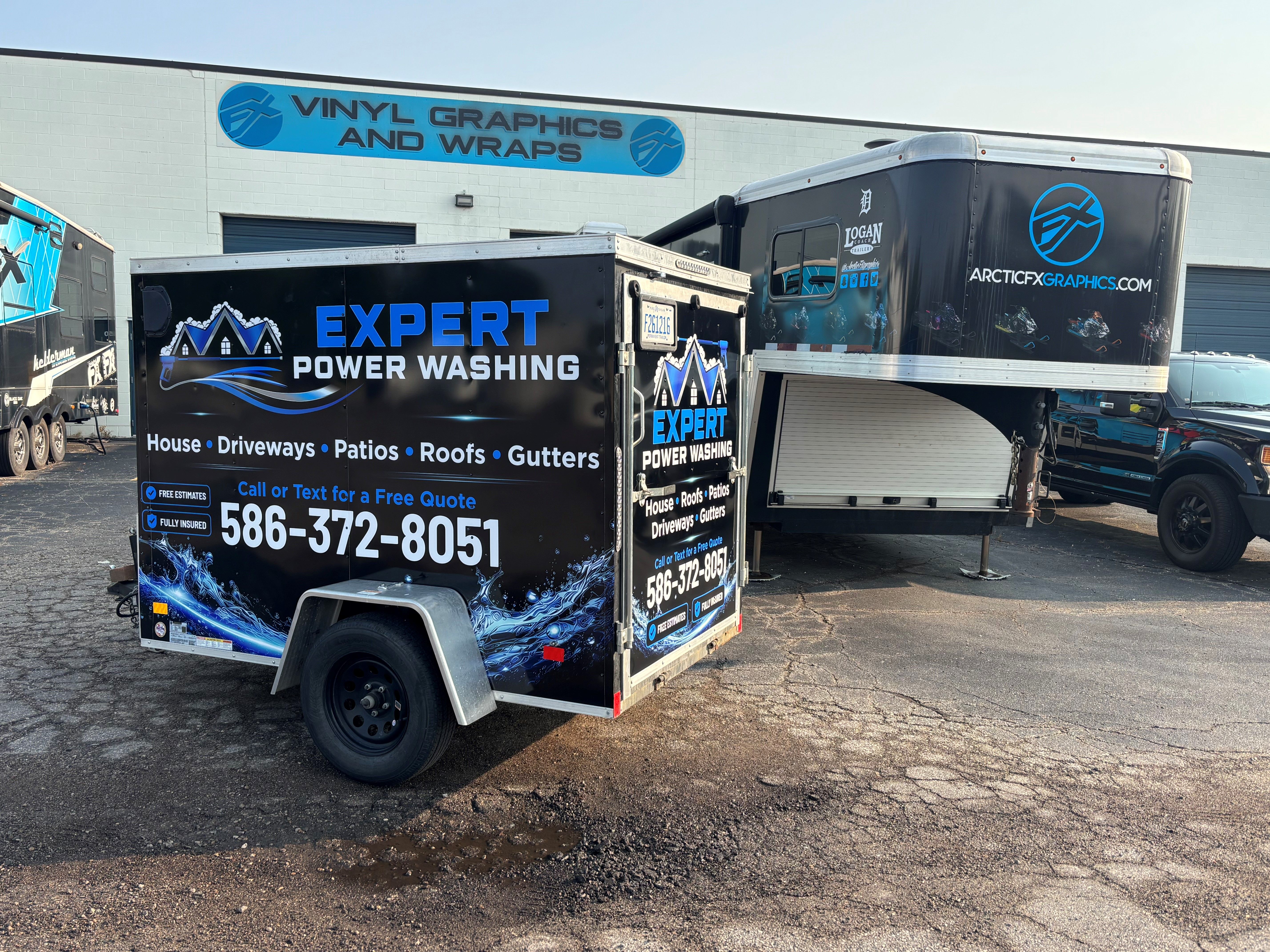 A commercial trailer with a custom vinyl wrap with blue and white text and logo