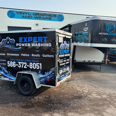 A commercial trailer with a custom vinyl wrap with blue and white text and logo