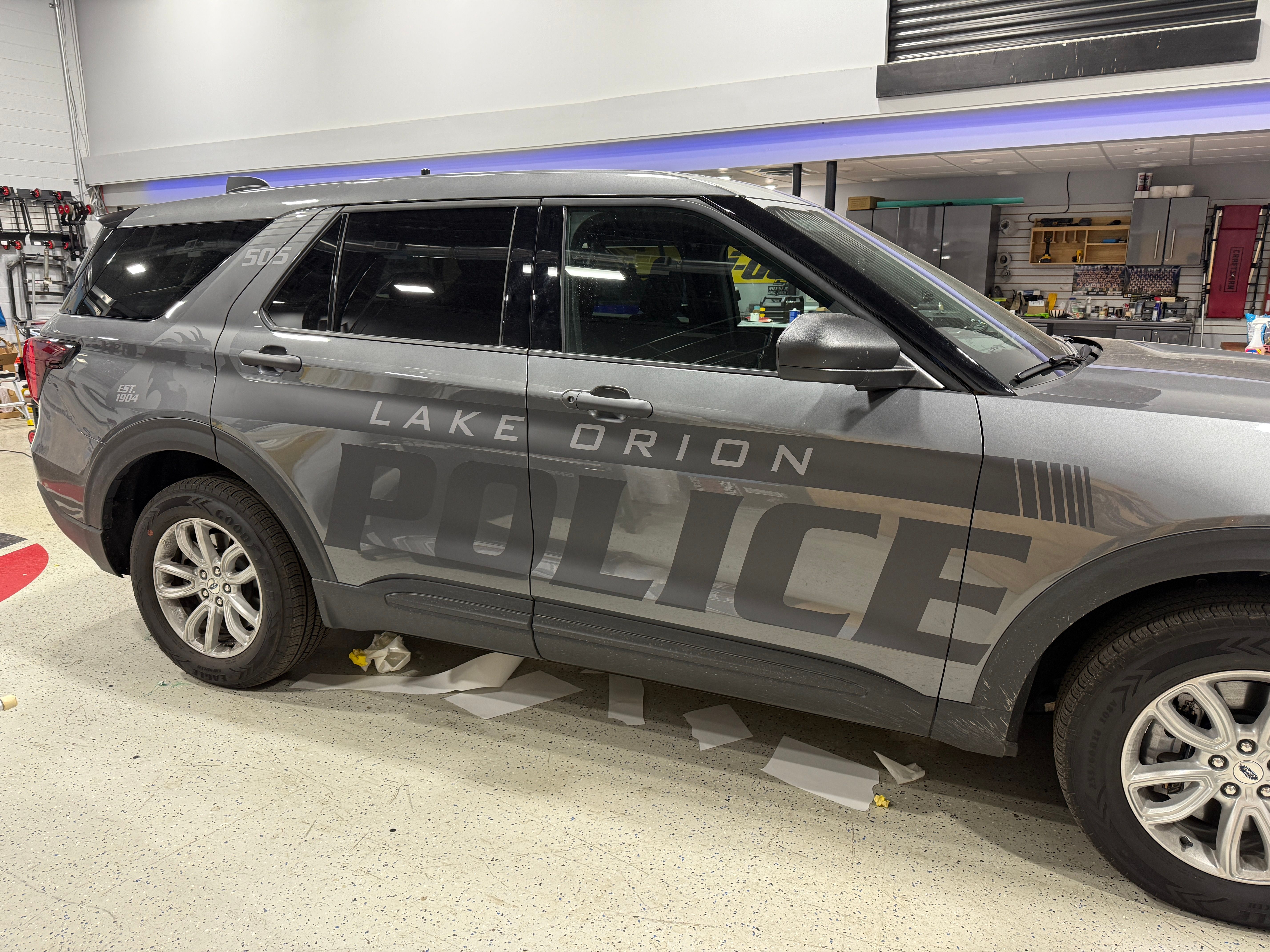 A police vehicle wrapped with a stealth matte design and livery