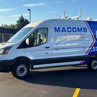 A commercial work van with a custom vinyl wrap with blue, white, and red text and logos
