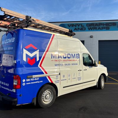 A commercial work van with a custom vinyl wrap with blue, white, and red text and logos