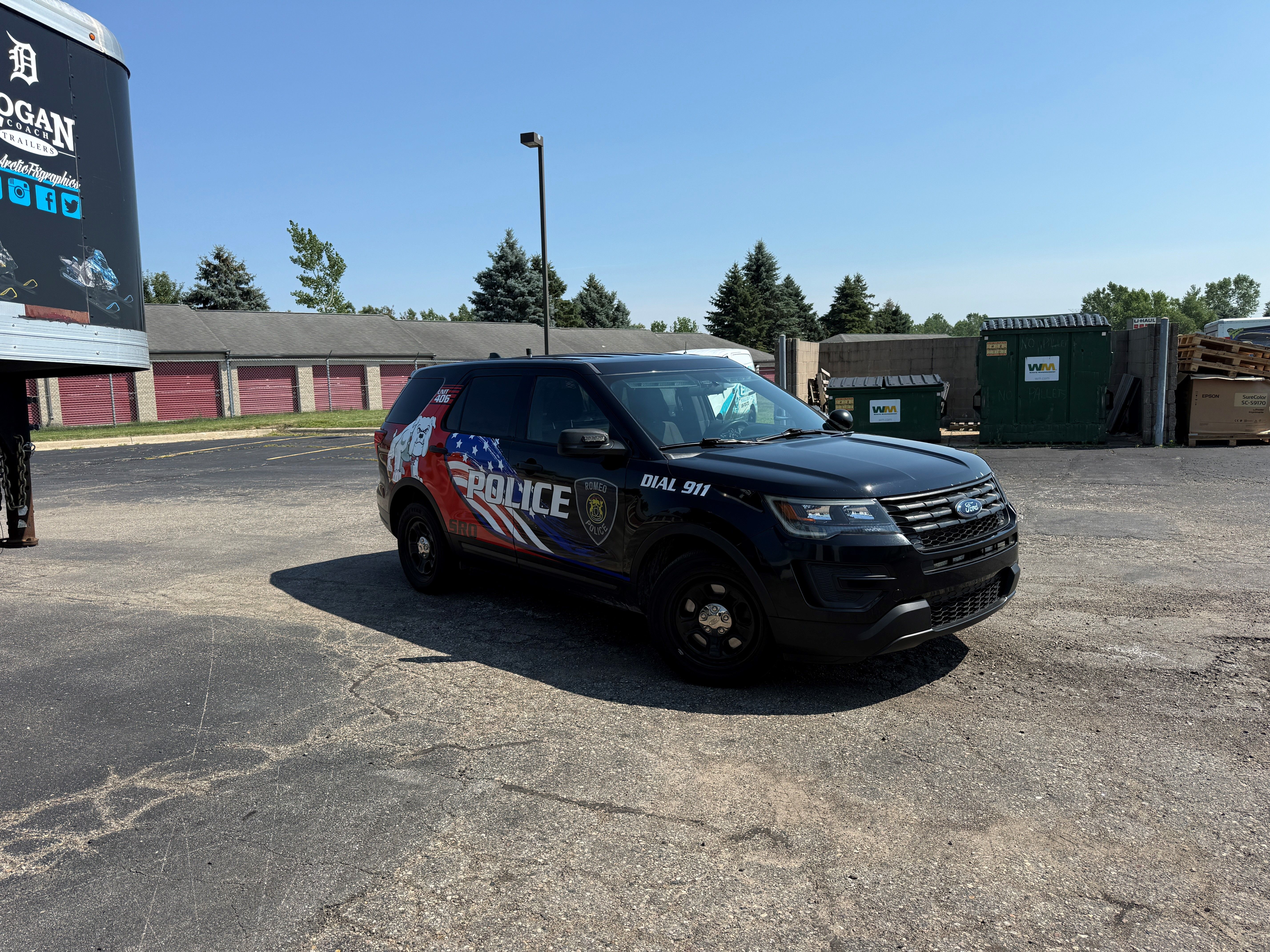 A police vehicle with an American Flag design vinyl wrap