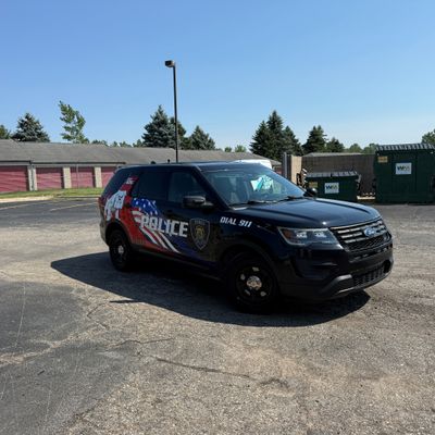 A police vehicle with an American Flag design vinyl wrap