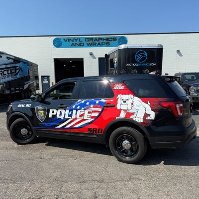 A police vehicle with an American Flag design vinyl wrap