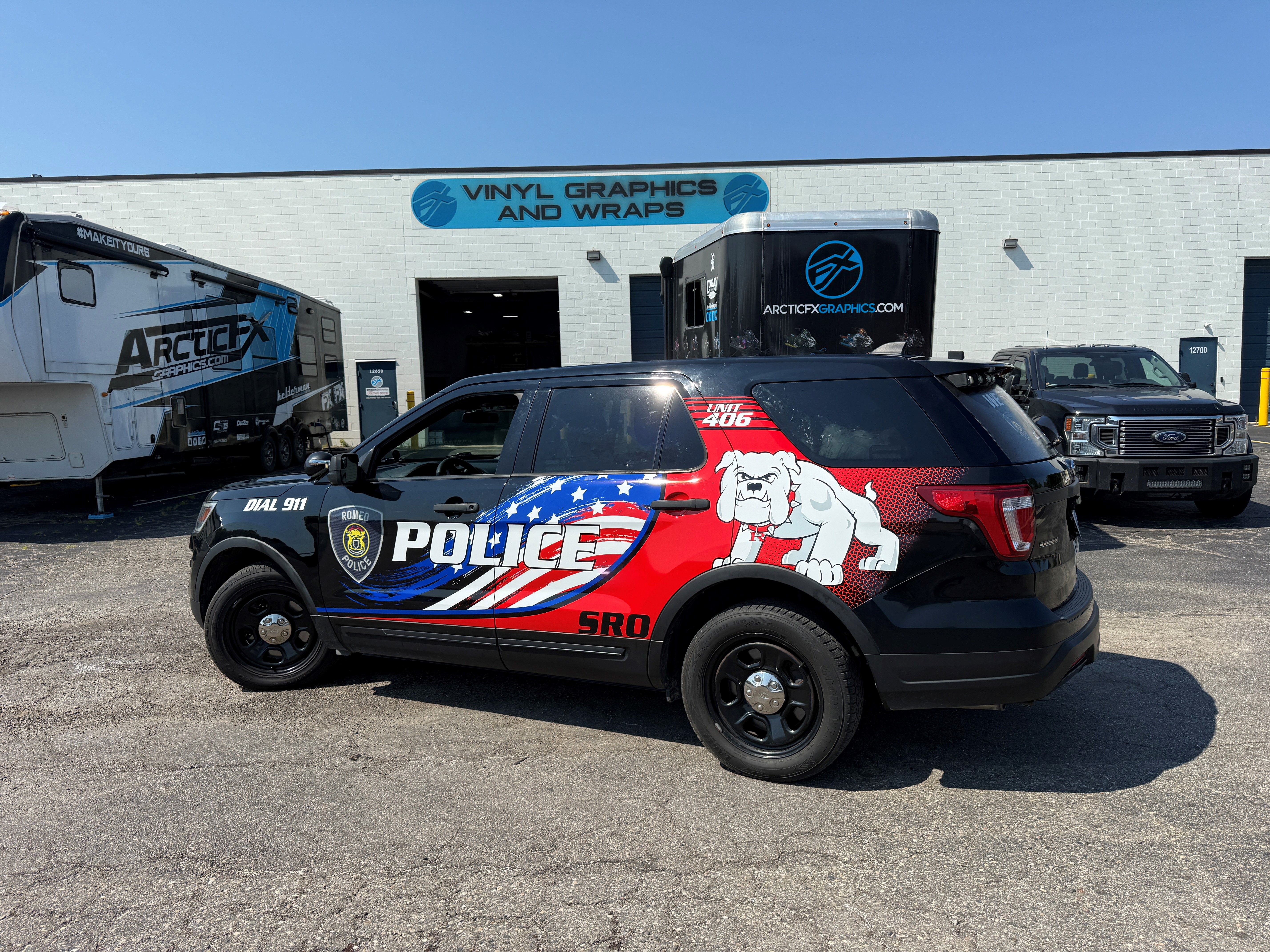 A police vehicle with an American Flag design vinyl wrap