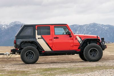 A personal jeep car with a custom vinyl wrap with tan and black stripes