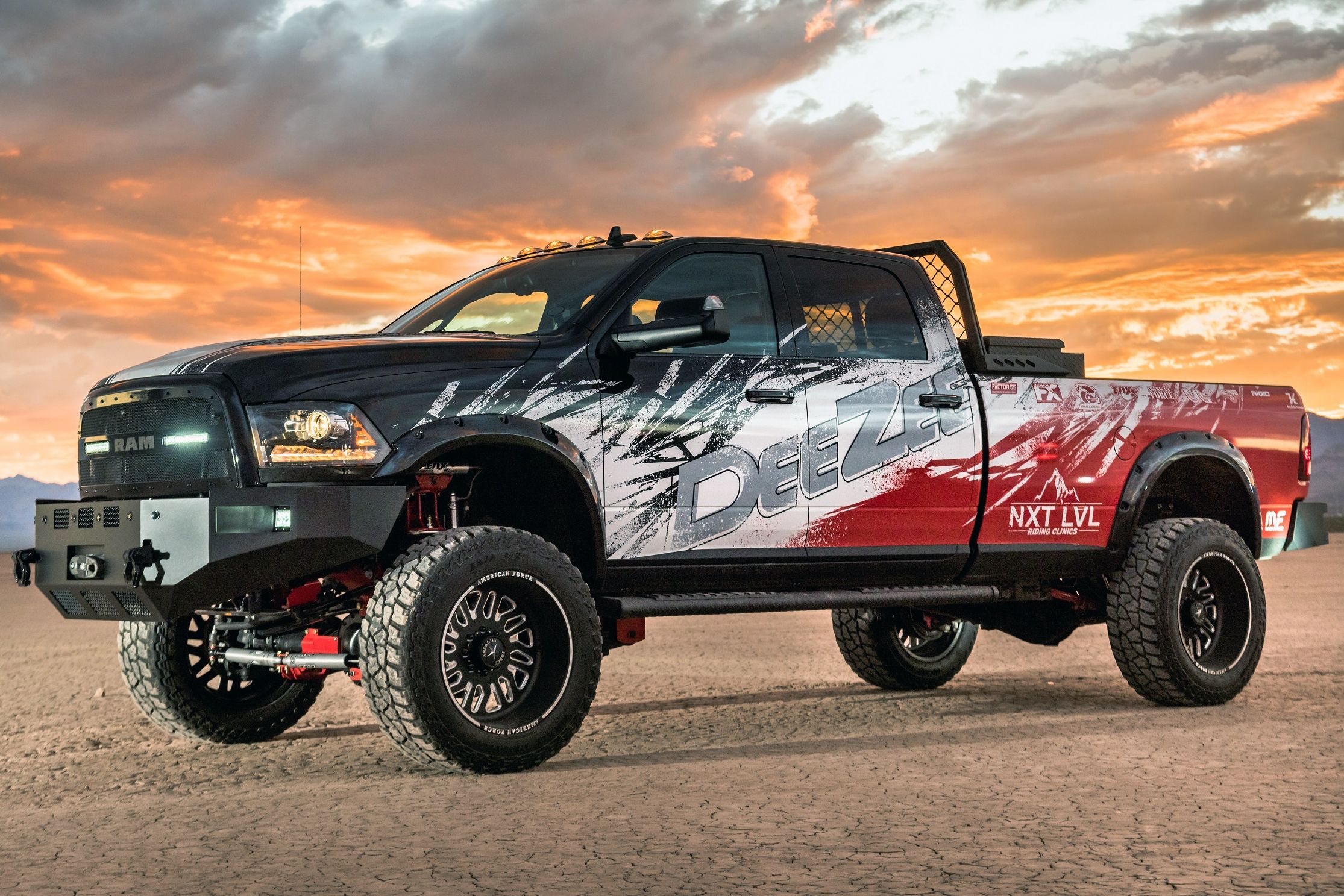 A commercial work truck with a custom vinyl wrap with red, white, and black logos and text with a grunge design