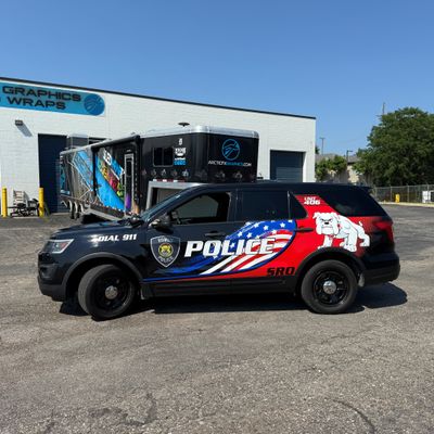 A police vehicle with an American Flag design vinyl wrap
